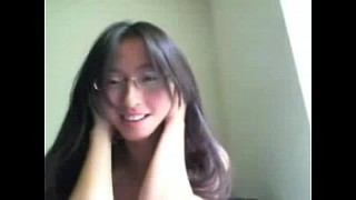 Handsome Asian woman cock teases with her jugs on webcam